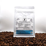 Coffee bag with label on a bed of coffee beans